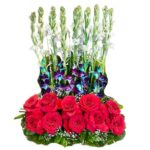A Designer Arrangement of Red Roses, Blue Orchids & Fragrant Rajnigandhas