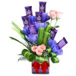 # 01 -  A Beautiful Arrangement of 7 Cadbury Chocolates & 6 Pink Roses in a Re-usable Glass Vase