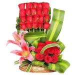 A Designer Basket of 30 Red Roses & 2 Buds of Pink Lilies with Exotic Leaves