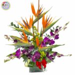 An Exotic Glass Vase of Birds of Paradise & Purple Orchids