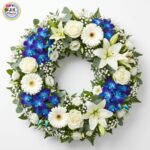 WREATH - of Blue Orchids, White Lilies, Roses & Gerberas (Medium)